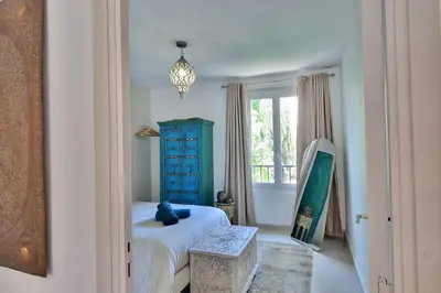 a bedroom with a bed and a blue cabinet at Rêves d'Orient - proche mer in Nice