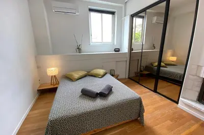 a bedroom with a bed and a mirror at 06BX Loft Pessicart in Nice
