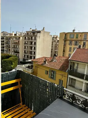 a bench sitting on top of a balcony with buildings at Chic Renovated Home - Nice Libération - Entire 2BR 2BA Apartment or Private Rooms with Private Bathrooms - AC and Garage on request in Nice