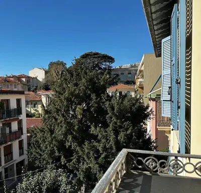 a tree on the balcony of a building at Chic Renovated Home - Nice Libération - Entire 2BR 2BA Apartment or Private Rooms with Private Bathrooms - AC and Garage on request in Nice