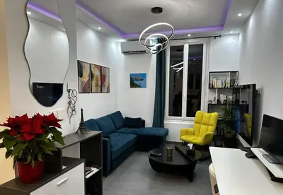 a living room with a blue couch at Chic Renovated Home - Nice Libération - Entire 2BR 2BA Apartment or Private Rooms with Private Bathrooms - AC and Garage on request in Nice