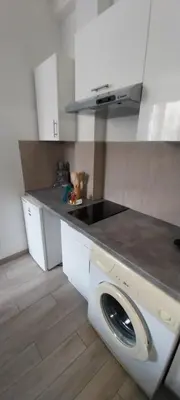 a kitchen with a washing machine in the middle at Charmant 2 pièces in Nice