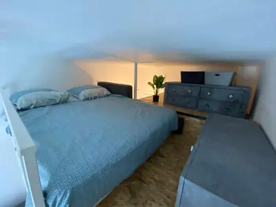 a bedroom with a blue bed with a dresser and a desk at Studio Hérold - Évasion avec Terrasse à Nice in Nice
