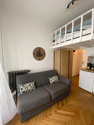 a living room with a couch and a loft bed at Studio Hérold - Évasion avec Terrasse à Nice in Nice