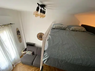 a bedroom with a bed and a couch in it at Studio Hérold - Évasion avec Terrasse à Nice in Nice