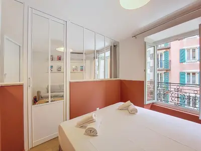 a room with a bed and a large window at Nestor&Jeeves - PLACE DU PIN - Near Port - Old town in Nice