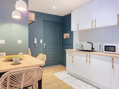 a kitchen with white cabinets and a table at Nestor&Jeeves - PLACE DU PIN - Near Port - Old town in Nice
