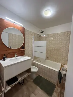 a bathroom with a sink and a toilet and a mirror at Studio à deux pas de la mer in Nice