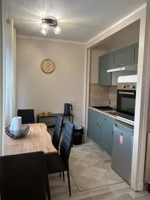 a kitchen and dining room with a table and chairs at Studio à deux pas de la mer in Nice