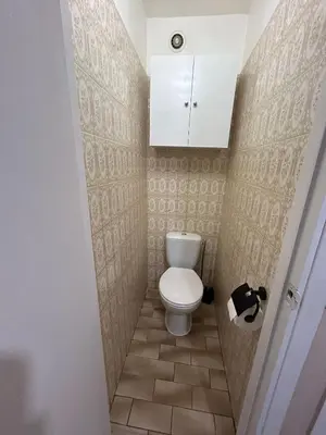 a small bathroom with a toilet and a white cabinet at Studio à deux pas de la mer in Nice