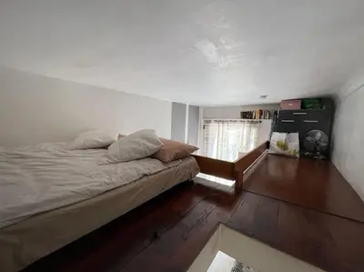 a bedroom with a bed and a wooden floor at Petit studio de charme in Villefranche-sur-Mer