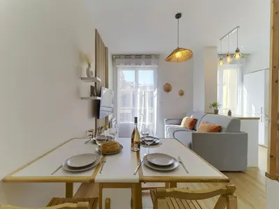a kitchen and living room with a table with plates on it at City Center - Magnificent Apartment - Cozy - Wifi in Nice