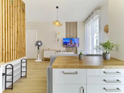 a kitchen and living room with white cabinets and a tv at City Center - Magnificent Apartment - Cozy - Wifi in Nice