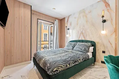 a bedroom with a bed in a room at Nice Renting - 7FRANCE - Suite Luxe & Confort Bord de Mer Massena in Nice