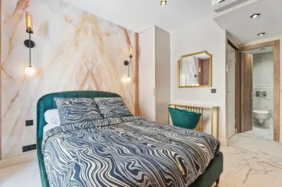 a bedroom with a bed and a bathroom at Nice Renting - 7FRANCE - Suite Luxe & Confort Bord de Mer Massena in Nice