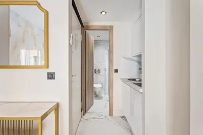 a bathroom with a marble floor and a mirror at Nice Renting - 7FRANCE - Suite Luxe & Confort Bord de Mer Massena in Nice