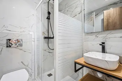 a white bathroom with a sink and a shower at Nice Renting - 7FRANCE - Suite Luxe & Confort Bord de Mer Massena in Nice
