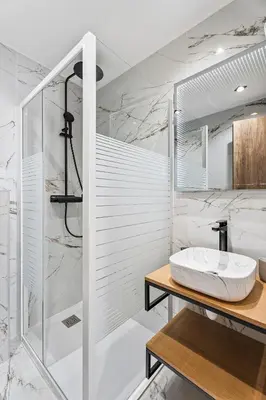 a white bathroom with a sink and a mirror at Nice Renting - 7FRANCE - Suite Luxe & Confort Bord de Mer Massena in Nice