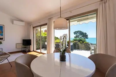a dining room with a white table and a view of the ocean at VILLA LA PETITE RESERVE VI4416 By Riviera Holiday in Èze