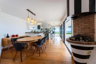 a kitchen and dining room with a wooden table and chairs at VILLA ADRIANA VI4411 By Riviera Holiday Homes in Nice