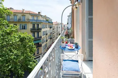 a balcony with a table and chairs on a balcony at #27 Urban Suite AC 2 Bedrooms 10mins Walk Sea&Old Town in Nice