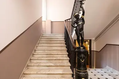 a staircase with a statue of a woman on a rail at #27 Urban Suite AC 2 Bedrooms 10mins Walk Sea&Old Town in Nice