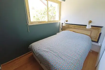 a small bedroom with a bed and a window at Refurbished apartment with terrace and garden in Nice