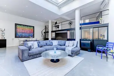 a living room with a blue couch and a table at Magnifique loft au cœur de Nice in Nice