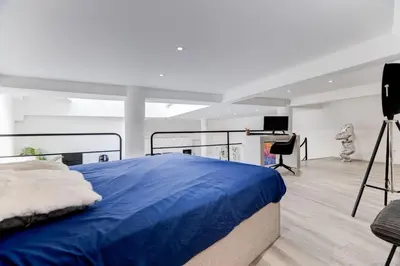 a bedroom with a large blue bed and a piano at Magnifique loft au cœur de Nice in Nice
