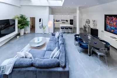 a living room with a blue couch and a dining room at Magnifique loft au cœur de Nice in Nice