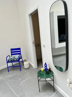 a room with a blue chair and a mirror at Magnifique loft au cœur de Nice in Nice