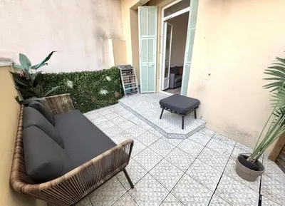 a couch and a chair sitting on a patio at ApartHotel Riviera - TERRASSE HORIZON - 15' Promenade des Anglais in Nice
