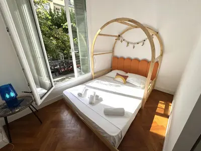 a small bed in a room with two windows at ApartHotel Riviera - TERRASSE HORIZON - 15' Promenade des Anglais in Nice
