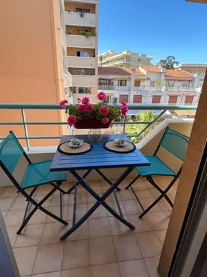 a blue table and chairs on a balcony at Studio proche promenade des anglais in Nice