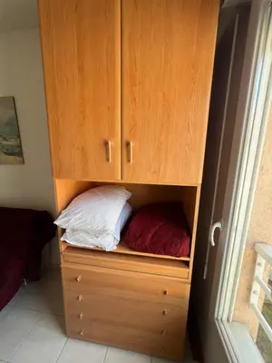 a wooden cabinet with two pillows in it at Magnifique 2 pièces centre Nice in Nice