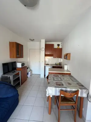 a kitchen with a table and a small kitchen with a tableablish at Magnifique 2 pièces centre Nice in Nice