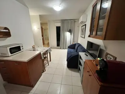 a kitchen and living room with a couch and a microwave at Magnifique 2 pièces centre Nice in Nice