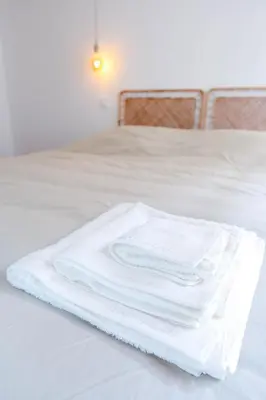 a pile of white towels sitting on top of a bed at Nice carré d'or proche Negresco in Nice