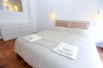 a white bed with two towels on top of it at Nice carré d'or proche Negresco in Nice