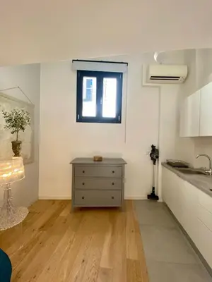 a kitchen with a dresser and a window at Studio Beautes FSHH in Nice