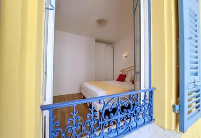 a small bedroom with a bed on a balcony at Nestor&Jeeves - BRISE DE NICE - Balcony - Central in Nice