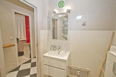a white bathroom with a sink and a mirror at Villa Rivoli City Center Nice in Nice