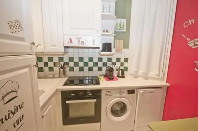 a small kitchen with a washing machine in it at Villa Rivoli City Center Nice in Nice