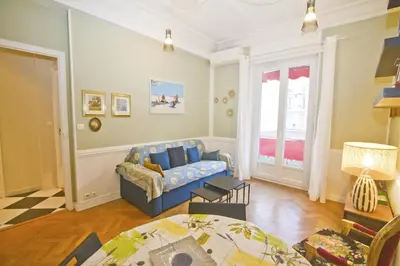 a living room with a blue couch and a table at Villa Rivoli City Center Nice in Nice