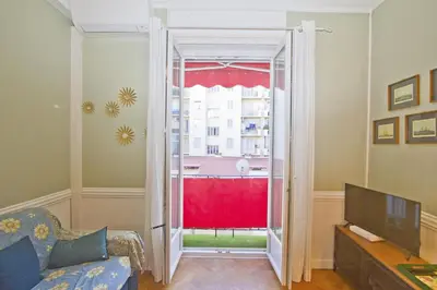 a living room with a tv and a sliding glass door at Villa Rivoli City Center Nice in Nice