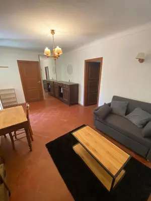 a living room with a couch and a table at L'Oustalet in Nice