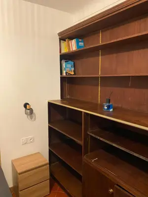 a book shelf with a desk in a room at L'Oustalet in Nice