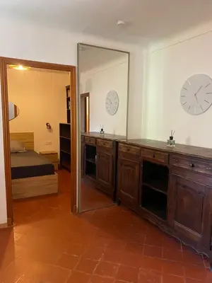 a room with a mirror and a bedroom with a bed at L'Oustalet in Nice