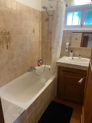 a bathroom with a tub and a sink at L'Oustalet in Nice