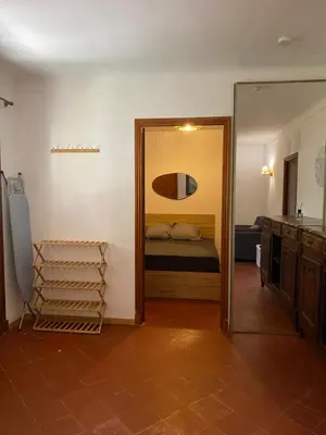 a room with a bedroom with a bed and a mirror at L'Oustalet in Nice